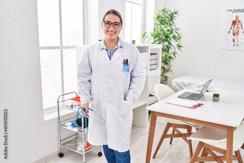 Young beautiful hispanic woman doctor smiling confident standing at clinic