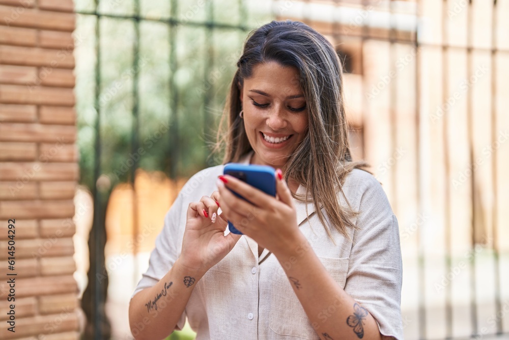 Young hispanic woman smiling confident using smartphone at street Young hispanic woman smiling confident using smartphone at street
