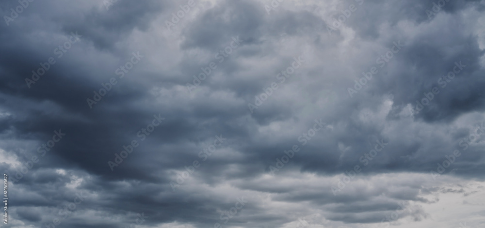 Overcast sky with dark clouds. Dark sky before a thunder-storm. The gray cloud background before rain.