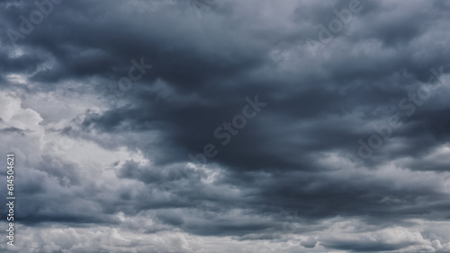 Overcast sky with dark clouds. Dark sky before a thunder-storm. The gray cloud background before rain.