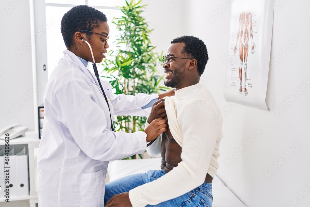 Man and woman doctor and patient having medical consultation auscultating chest at clinic Man and woman doctor and patient having medical consultation auscultating chest at clinic