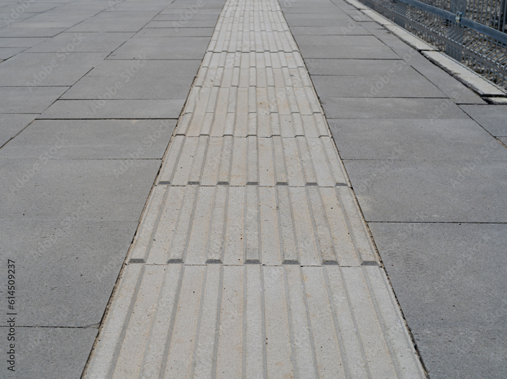 Fototapeta premium Tactile Paving on Modern Tiles Pathway for Blind Handicap, Safety Sidewalk Walkway for Disability People