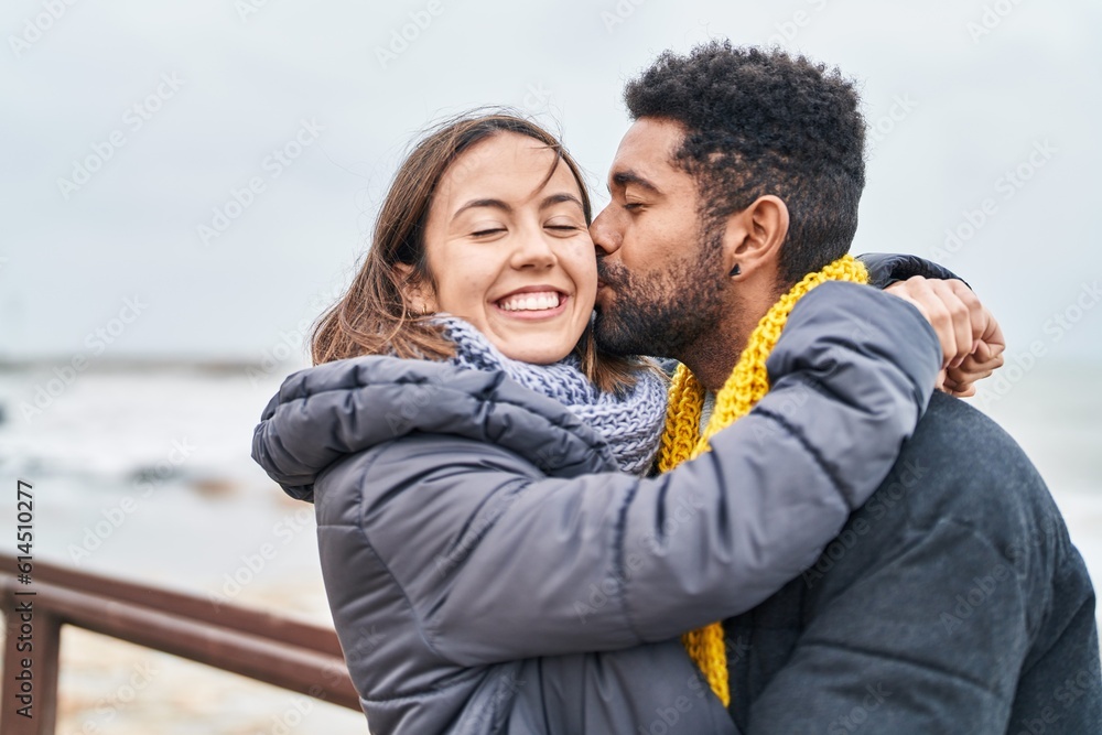 Man and woman couple hugging each other kissing at seaside Man and woman couple hugging each other kissing at seaside