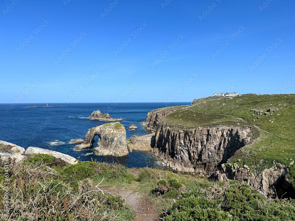 Land’s End in Cornwall coastline. Spectacular coastline view at Lands End in Cornwall, England, UK. The rocky coastal formation of the Conservation Park at Lands End, Cornwall. Ents Dodnan arch view.