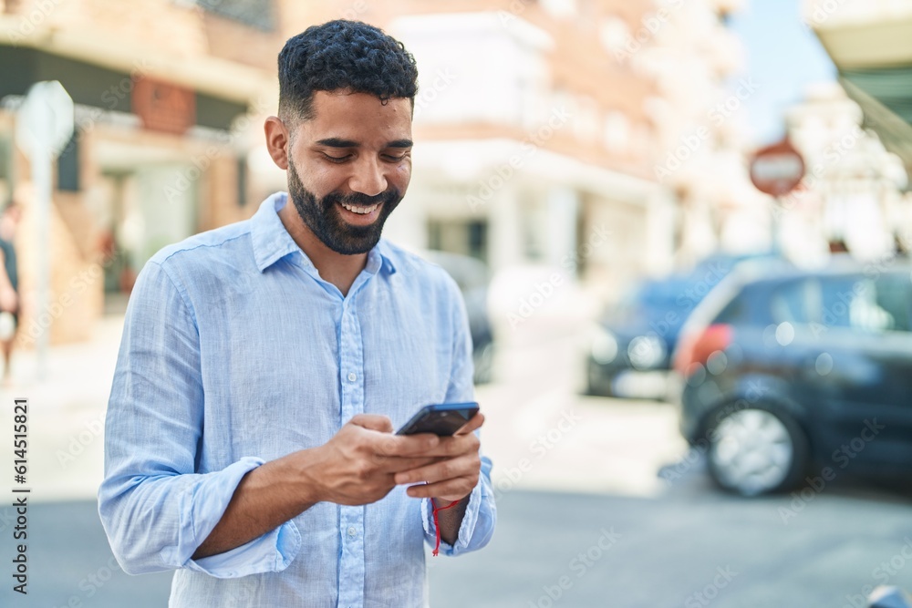 Young arab man smiling confident using smartphone at street Young arab man smiling confident using smartphone at street