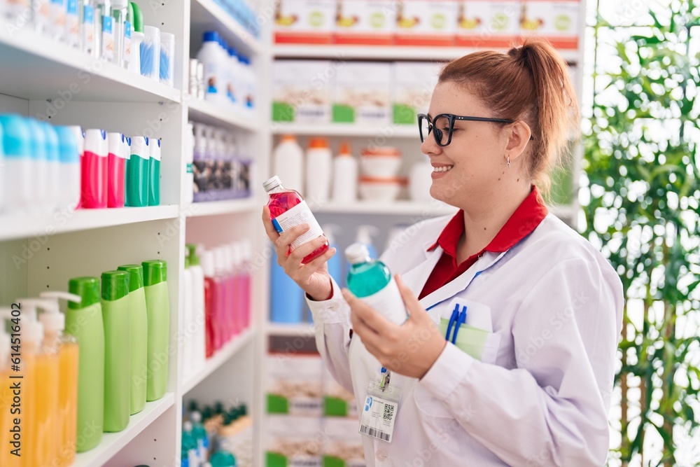 Young beautiful plus size woman pharmacist smiling confident holding medication bottles at pharmacy