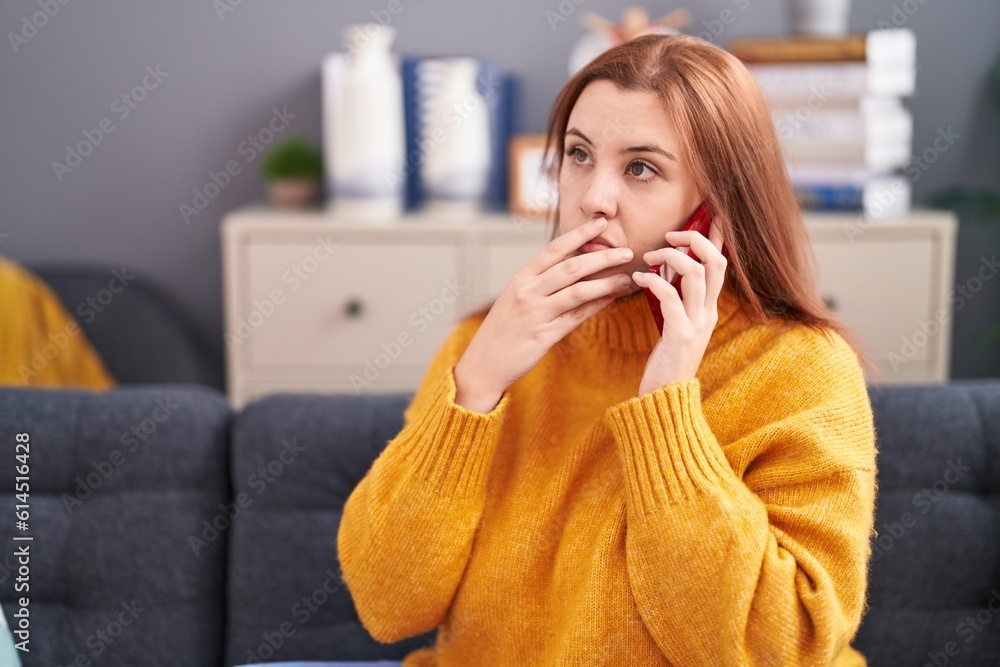 Young beautiful plus size woman talking on smartphone with worried expression at home Young beautiful plus size woman talking on smartphone with worried expression at home