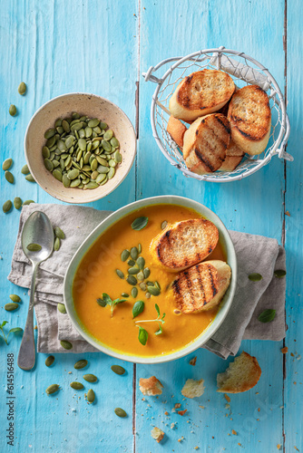 Vegan pumpkin soup served w...