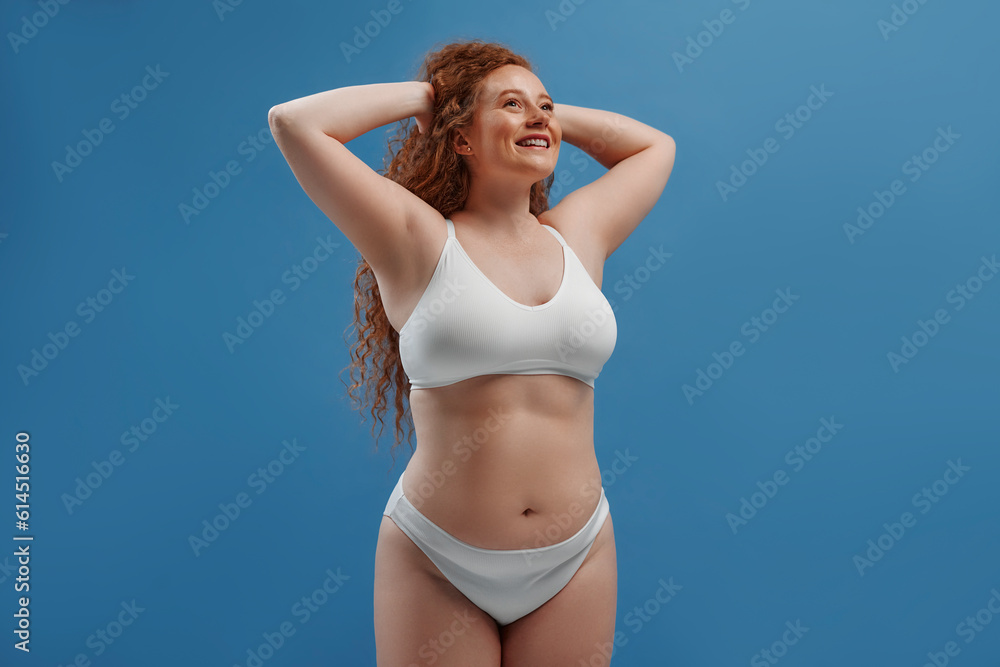 Redhead girl with freckles on a blue background Redhead girl with freckles on a blue background