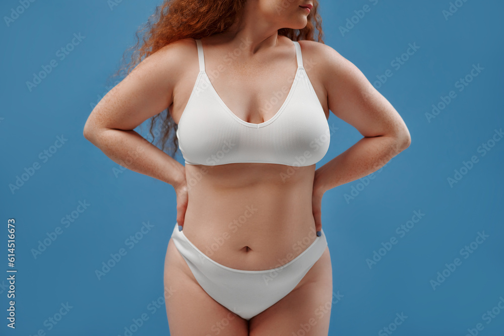 Redhead girl with freckles on a blue background Redhead girl with freckles on a blue background