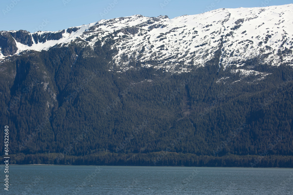 scenic landscape photograph of the snowcapped mountains of Alaska from the ocean view.