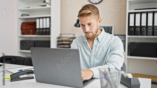 Young caucasian man business worker using laptop working at office