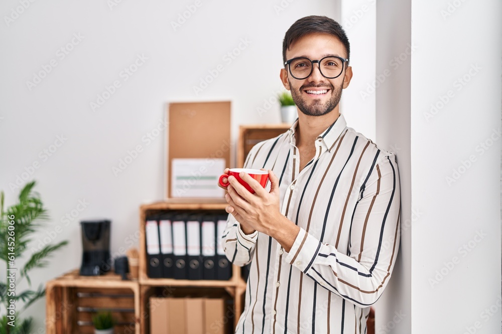 Young hispanic man business worker smiling confident drinking coffee at office Young hispanic man business worker smiling confident drinking coffee at office