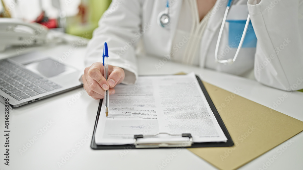 Young beautiful hispanic woman doctor writing medical report at clinic Young beautiful hispanic woman doctor writing medical report at clinic
