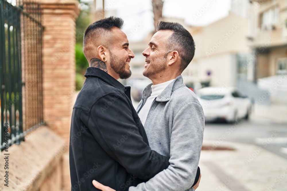 Two men couple smiling confident hugging each other at street Two men couple smiling confident hugging each other at street