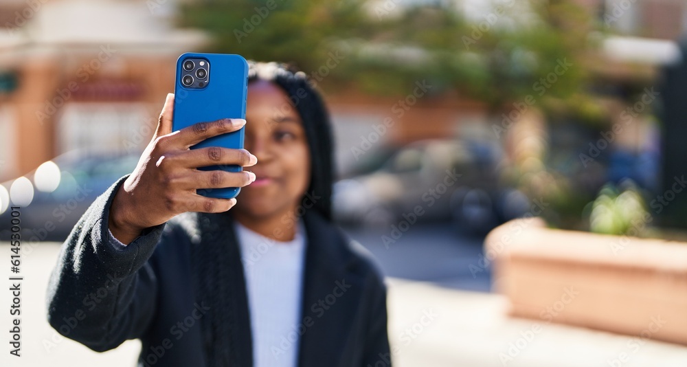 African american woman smiling confident making selfie by the smartphone at street African american woman smiling confident making selfie by the smartphone at street