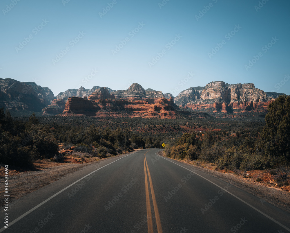 Highway view towards mountains of Sedona, Arizona. Bell Rock and Cathedral mountain is a butte just north of Village of Oak Creek, Arizona, south of Sedona in Yavapai County.USA. Highway view towards mountains of Sedona, Arizona. Bell Rock and Cathedral mountain is a butte just north of Village of Oak Creek, Arizona, south of Sedona in Yavapai County.USA.