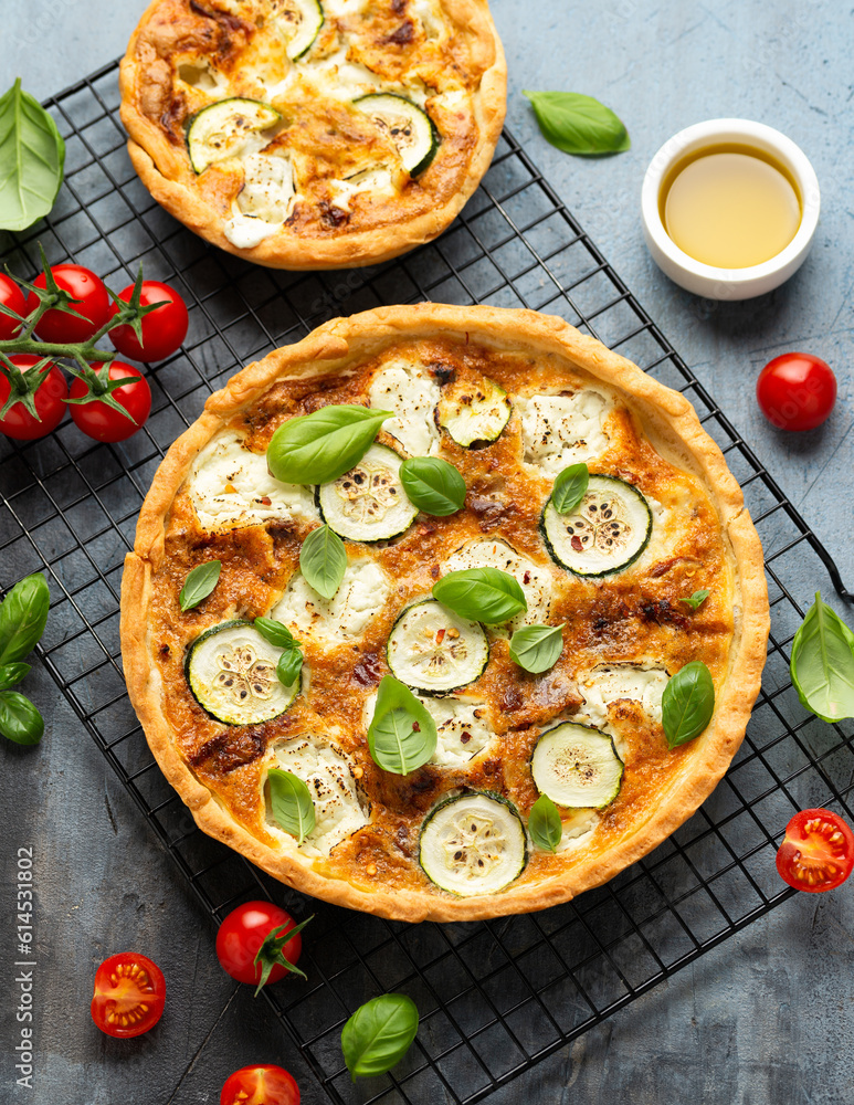 Sun baked tomato, goats cheese and courgette quiche served in cast iron pan with side salad