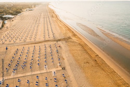 Morning on the still deserted beach. Umbrella beach for relaxing and sun set beach. Bibione, Italy