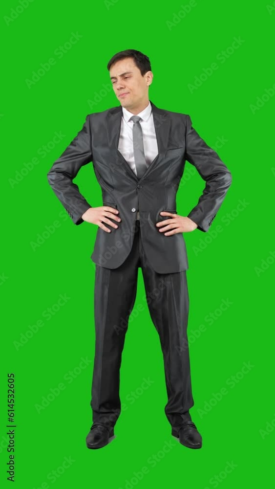 Bored elegant businessman with folded arms looking at camera Bored elegant businessman with folded arms looking at camera