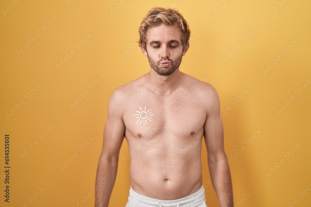 Caucasian man standing shirtless wearing sun screen making fish face with lips, crazy and comical gesture. funny expression.