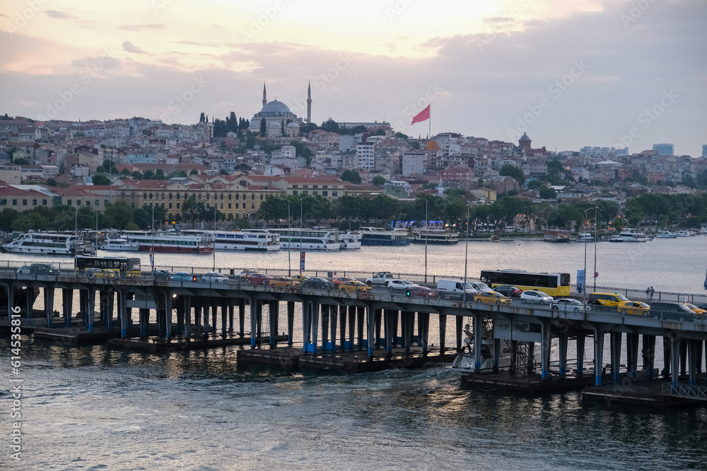 High angle shot of Unkapanı bridge view in Istanbul with sunset, sea, sky, buildings, and mosque. 