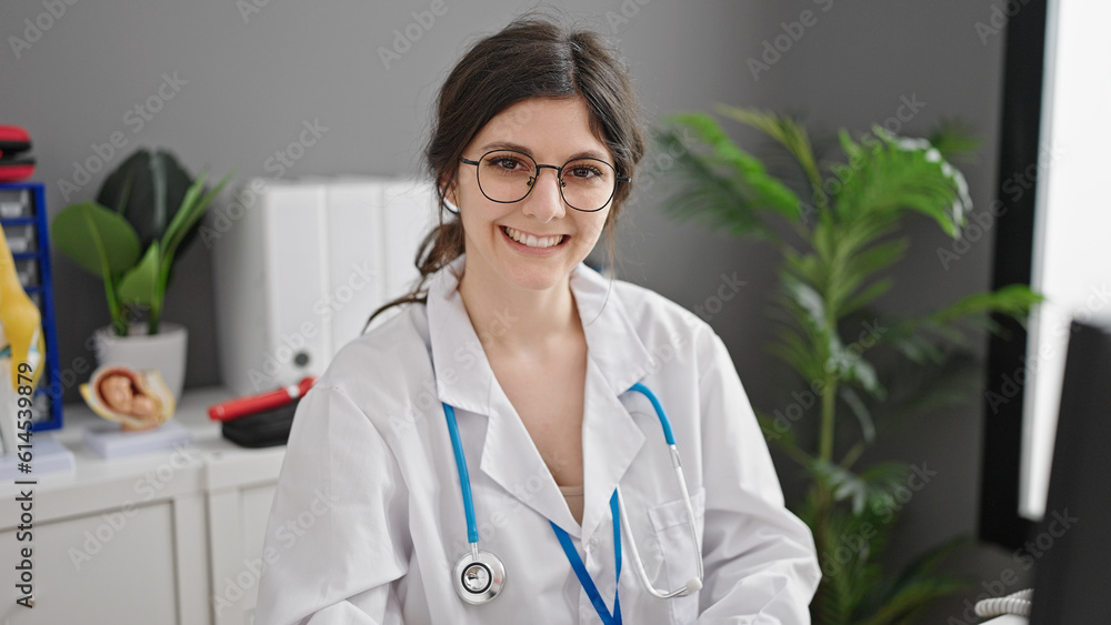Young beautiful hispanic woman doctor using computer working at clinic Young beautiful hispanic woman doctor using computer working at clinic