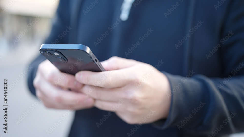 Young chinese man using smartphone at street Young chinese man using smartphone at street