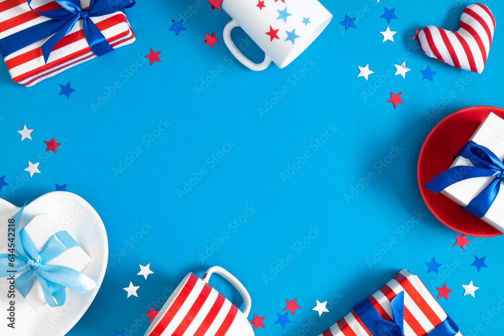 Obraz premium 4th of July, USA Presidents Day, Independence Day, US election concept. Gift striped box with bow, cup in stars, plate, star confetti on blue background. Flat lay, top view, copy space