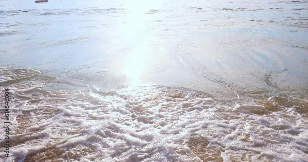 Wave breaks on shore in summer sunlight. Sea coast slowmotion video Wave breaks on shore in summer sunlight. Sea coast slowmotion video