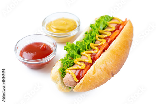 Homemade Hot Dog with yellow mustard, ketchup, tomato and fresh salad leaves isolated on white background. Fast food, street food, american cuisine