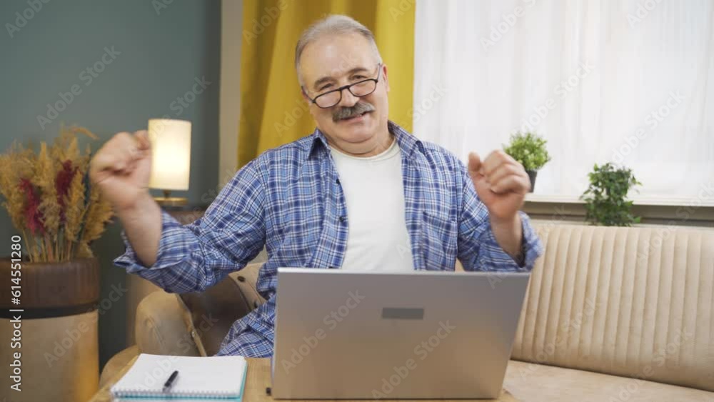 Man looking at laptop is happy and dancing. Man looking at laptop is happy and dancing.