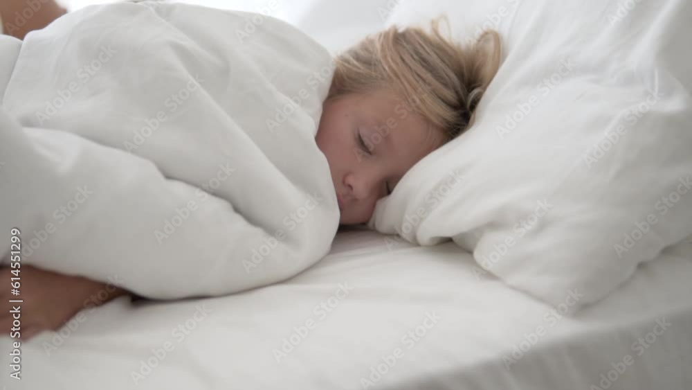 Sleepy little girl lying in bed in the morning Sleepy little girl lying in bed in the morning