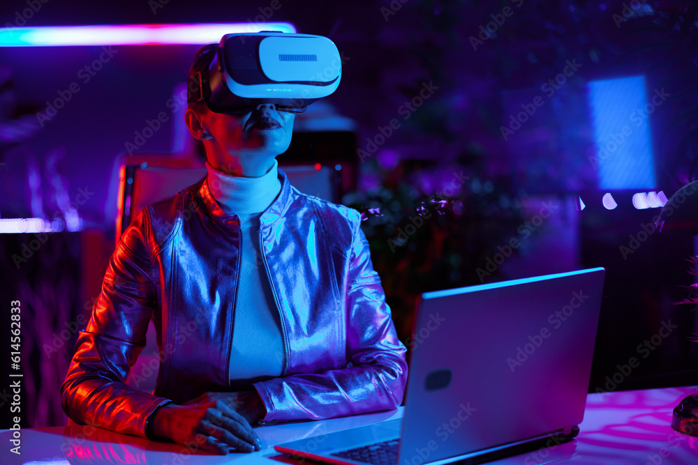 trendy 40 years old woman in virtual reality goggles in office trendy 40 years old woman in virtual reality goggles in office