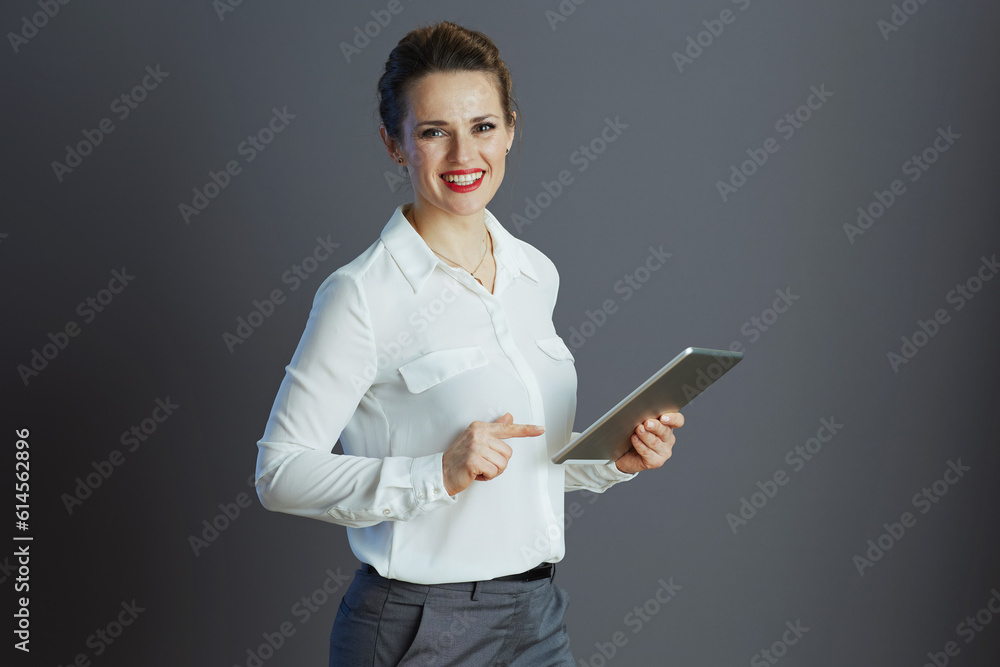 smiling trendy female worker against gray background smiling trendy female worker against gray background