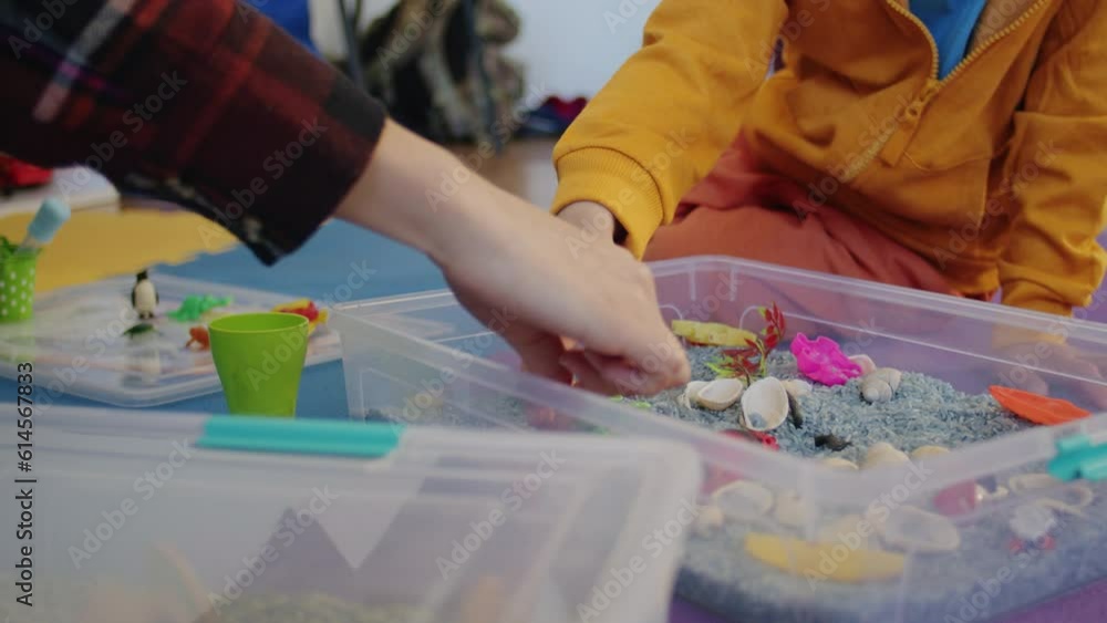 The little boy and his babysitter play a game in the car while staying warm with underfloor heating in their home. The little boy and his babysitter play a game in the car while staying warm with underfloor heating in their home.