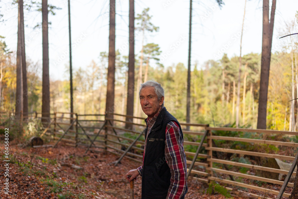 Portrait of an elderly man in a plaid shirt in the autumn forest Portrait of an elderly man in a plaid shirt in the autumn forest