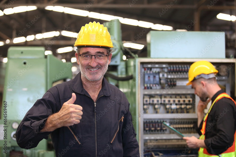 Supervisorand Young Engineer Working with big machine. Supervisorand Young Engineer Working with big machine.