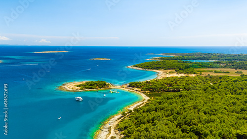 View from the air on the sea and coast. Sea relaxation and travel. The forest near the sea. Azure water on the sea. A bright sunny day during a summer vacation.