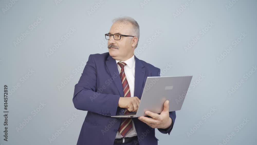 Businessman looking at laptop with scared expression. Businessman looking at laptop with scared expression.