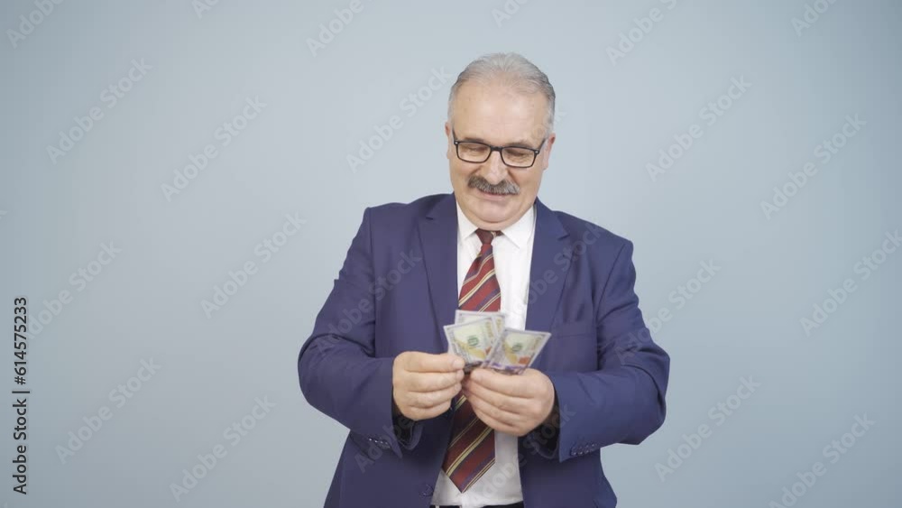 Businessman counting money looking at camera. Businessman counting money looking at camera.