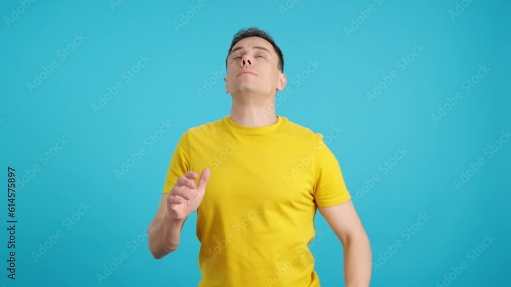 Man with a cold sneezes and blows his nose Man with a cold sneezes and blows his nose