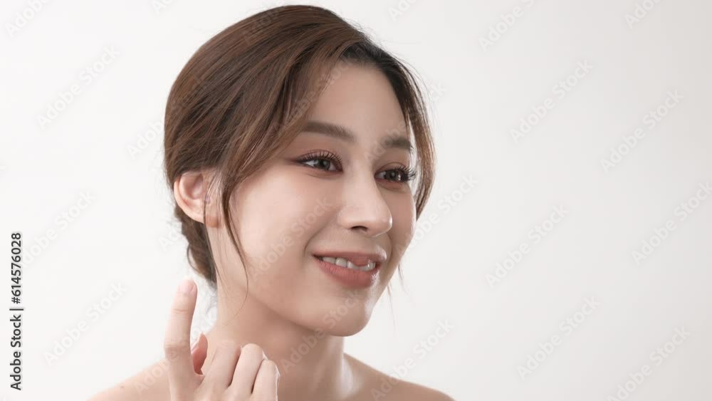 Beauty concept of 4k Resolution. Asian girl is touching her face on a white background. Beauty concept of 4k Resolution. Asian girl is touching her face on a white background.