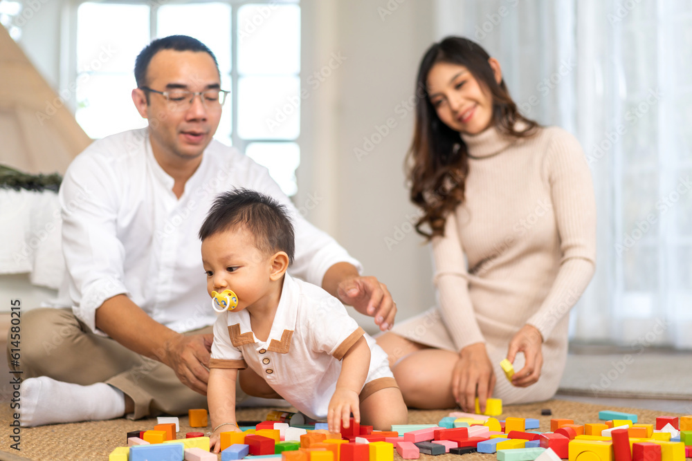 Portrait of enjoy happy love asian family father and mother with little asian baby smiling activity learn and skill brain training play with toy build wooden blocks board education game at home Portrait of enjoy happy love asian family father and mother with little asian baby smiling activity learn and skill brain training play with toy build wooden blocks board education game at home