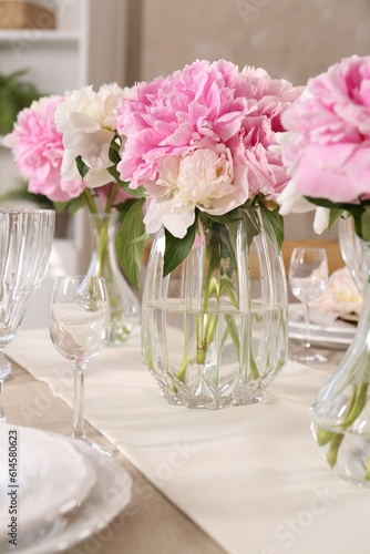 Stylish table setting with beautiful peonies indoors