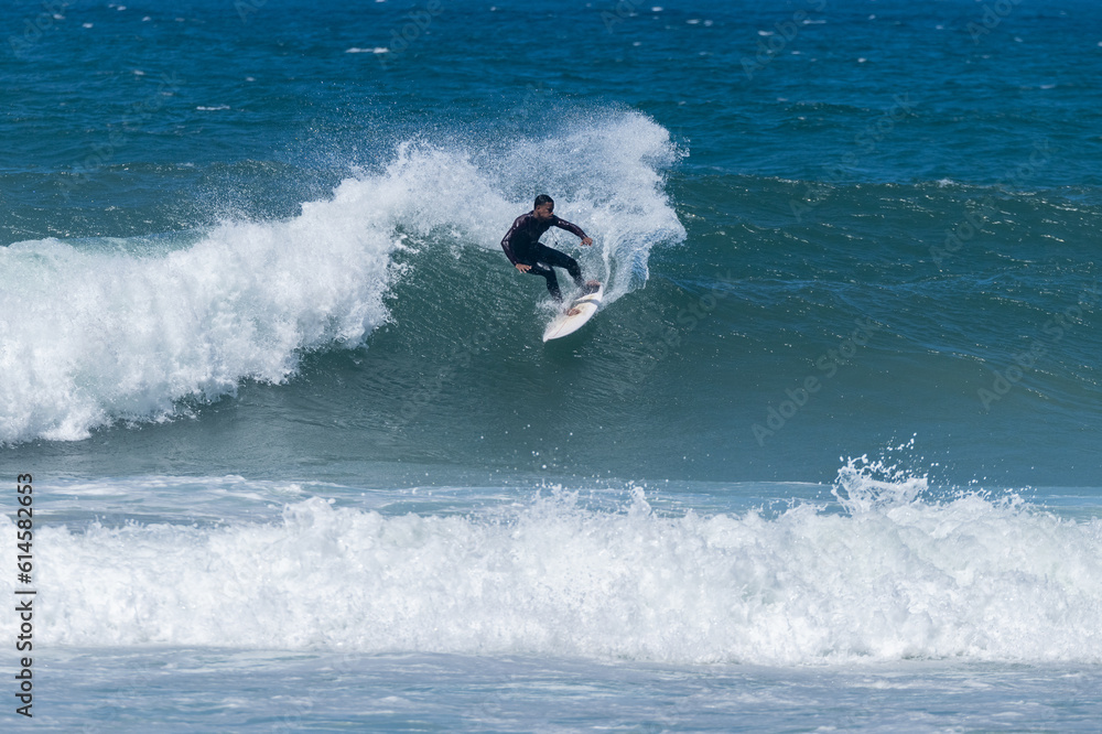 Surfer riding waves in Furadouro Beach Surfer riding waves in Furadouro Beach
