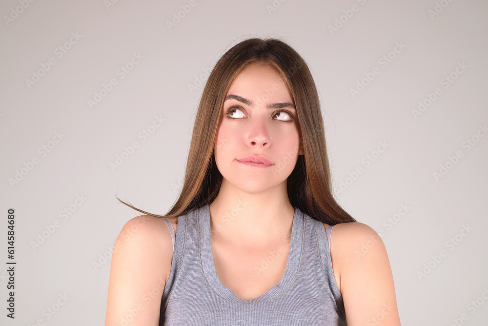 Thougthful thinking woman looks pensively aside makes plannings isolated on gray background. Beauty woman considers. Portrait of pensive thinking woman. Thoughtful girl thinking decision. Thougthful thinking woman looks pensively aside makes plannings isolated on gray background. Beauty woman considers. Portrait of pensive thinking woman. Thoughtful girl thinking decision.