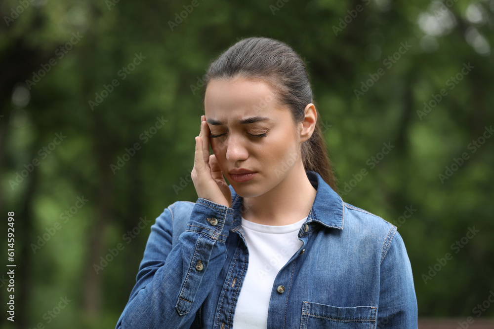 Woman suffering from seasonal spring allergy outdoors Woman suffering from seasonal spring allergy outdoors