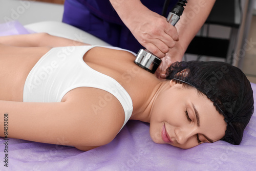 Woman undergoing radio frequency lifting procedure in beauty salon, closeup