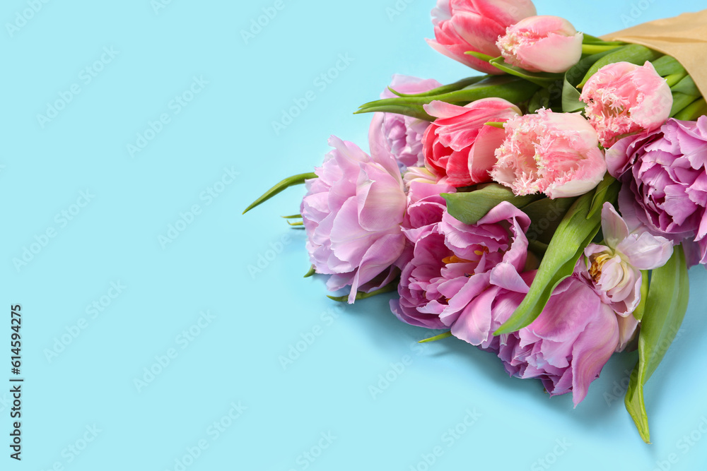Beautiful bouquet of colorful tulip flowers on light blue background, space for text